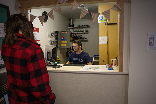 student works behind desk